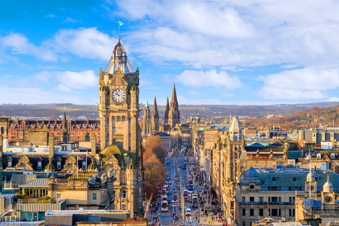 Edinburgh Princes Street from Calton Hill with views of Balmoral Clock tower, shops and spires