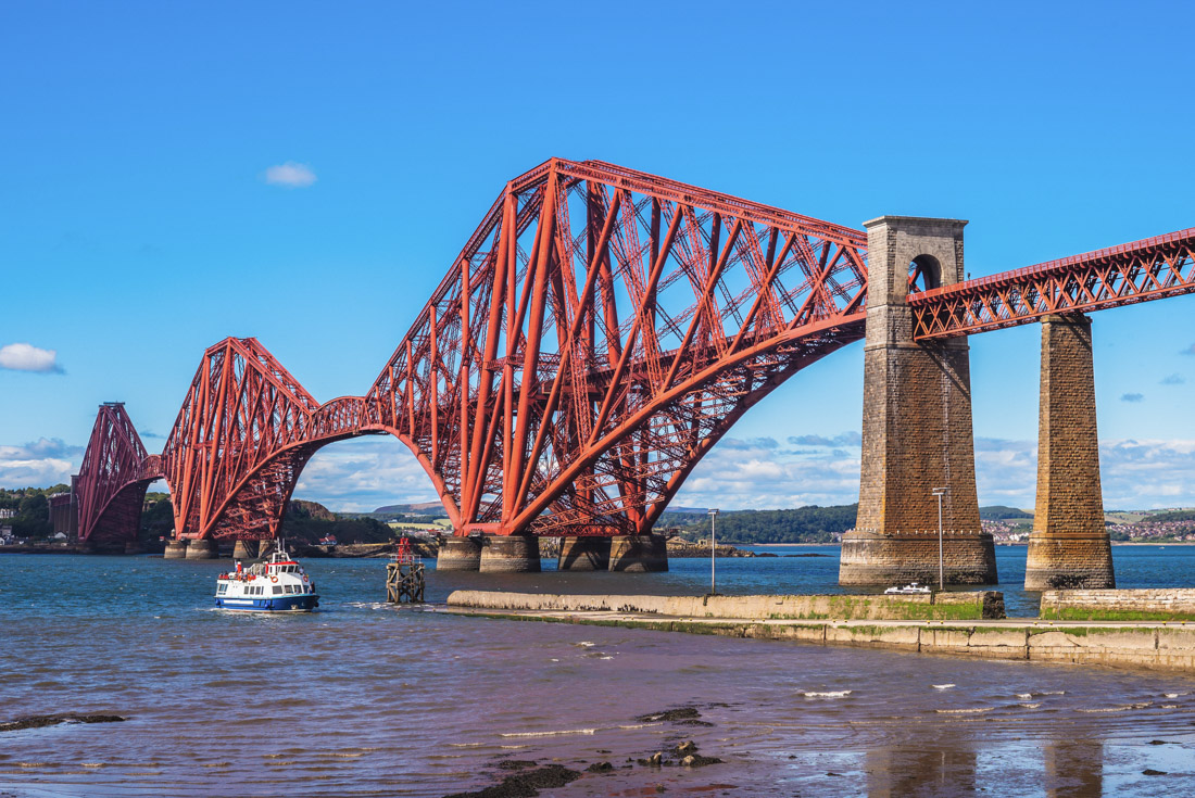 Red Forth Rail Bridge over blue ocean Firth of Forth