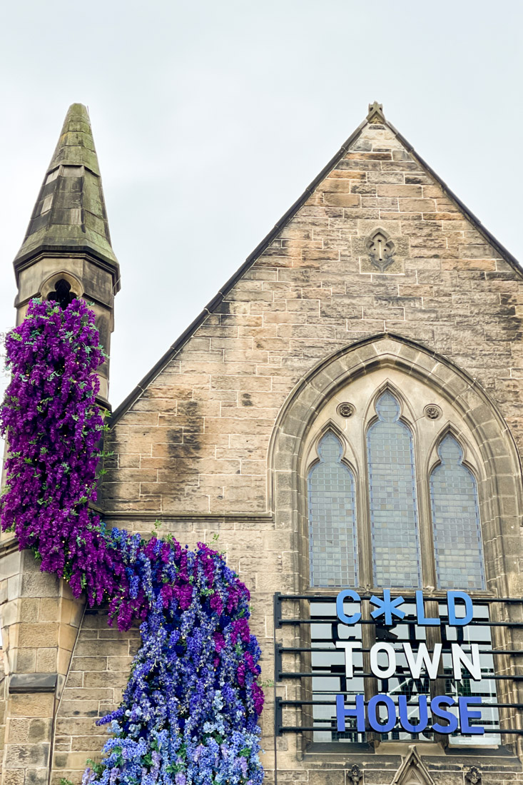 Purple flower display down the side of Cold Town House building on Edinburgh Grassmarket