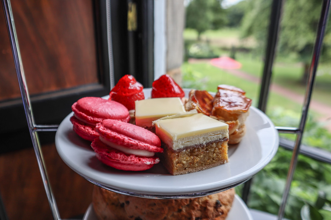 Colourful cakes perched on afternoon tea stand by window at Prestonfield House