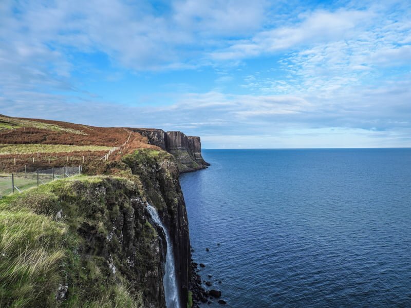 Kilt Rock flowing from mossy green cliff on Isle of Skye in Scotland