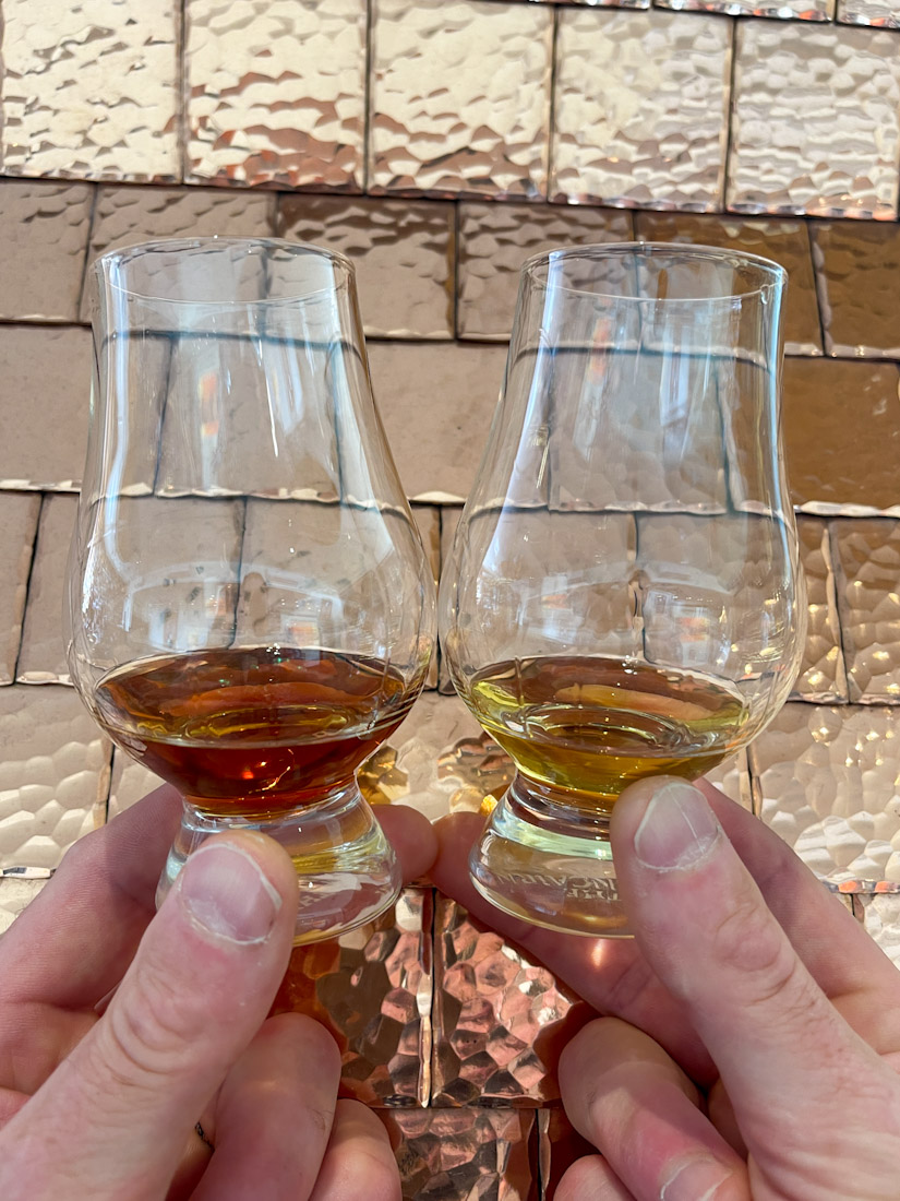 Hands holding up glasses of whisky