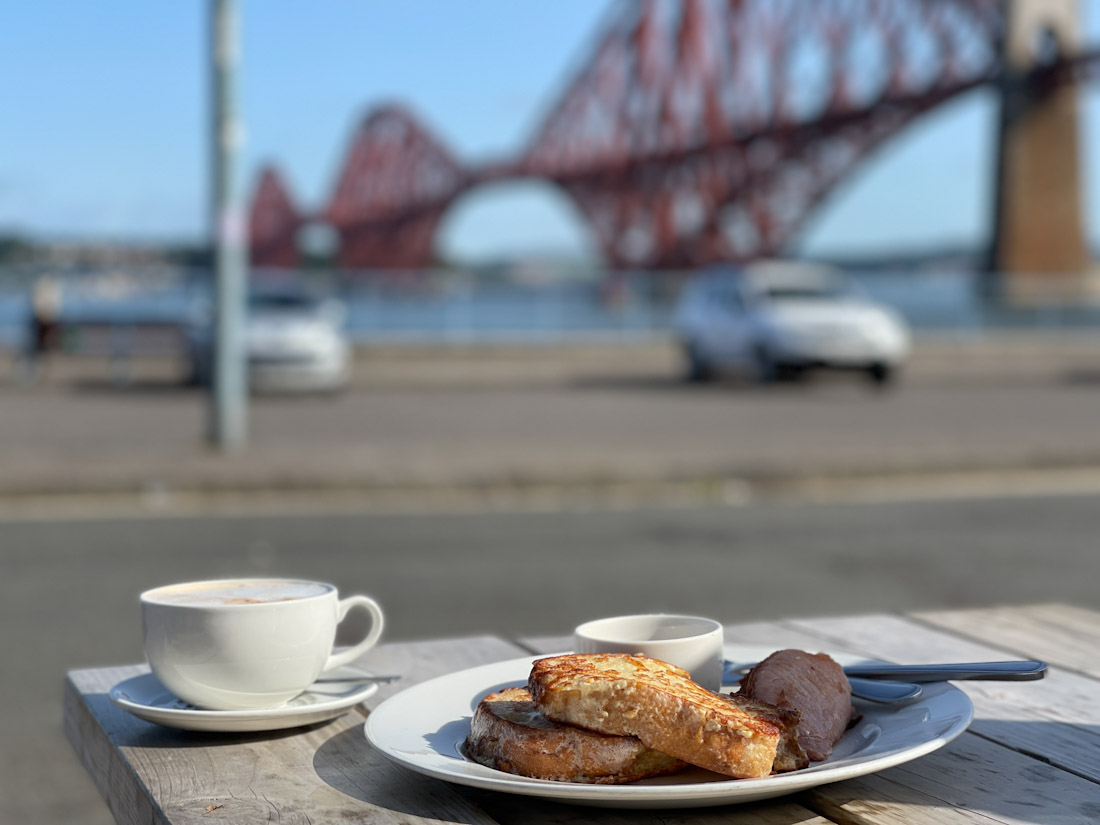 Breakfast on table with red Forth Bridge in background at Railway Bridge Bistro in South Queensferry brunch
