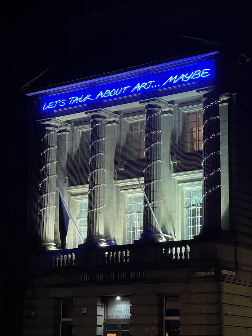 Let’s talk about art maybe lit up sign on Inn On The Mile hotel Edinburgh