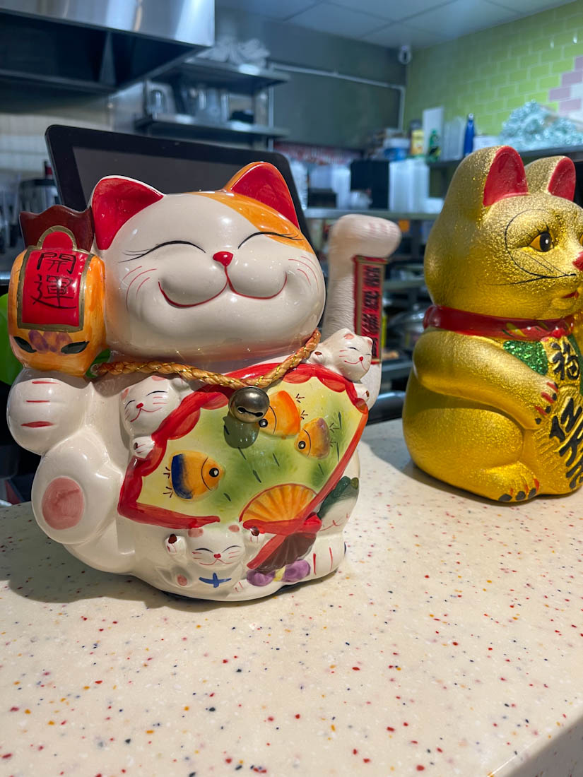 Smiling cat ornament at Sushi Stop