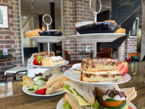 Afternoon tea platter on stacked trays at Holy Cow Edinburgh