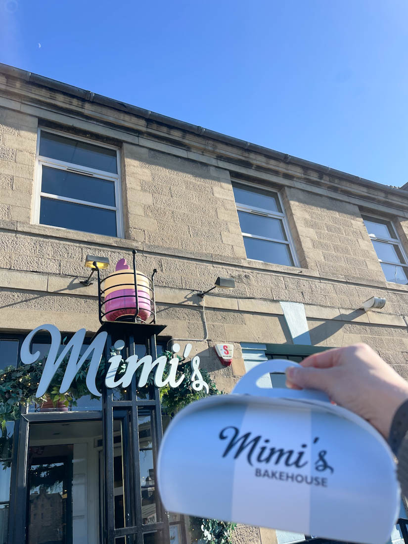 Hand holding take out outside of Mimi’s Leith Cafe Edinburgh